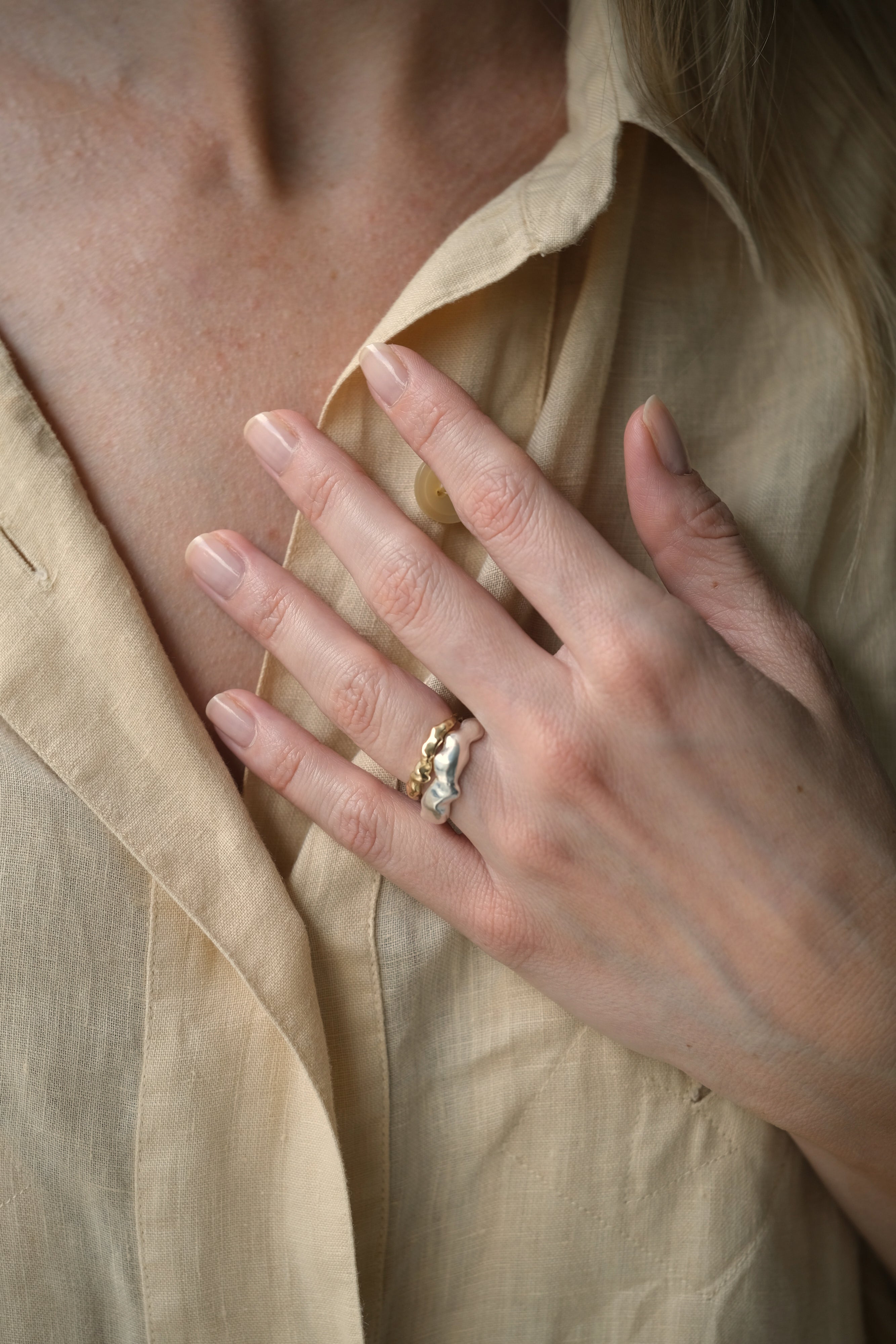 Hand wearing DROP 03 ring made of sustainable 925 recycled silver, showcasing unique design, handmade in Basel, Switzerland.