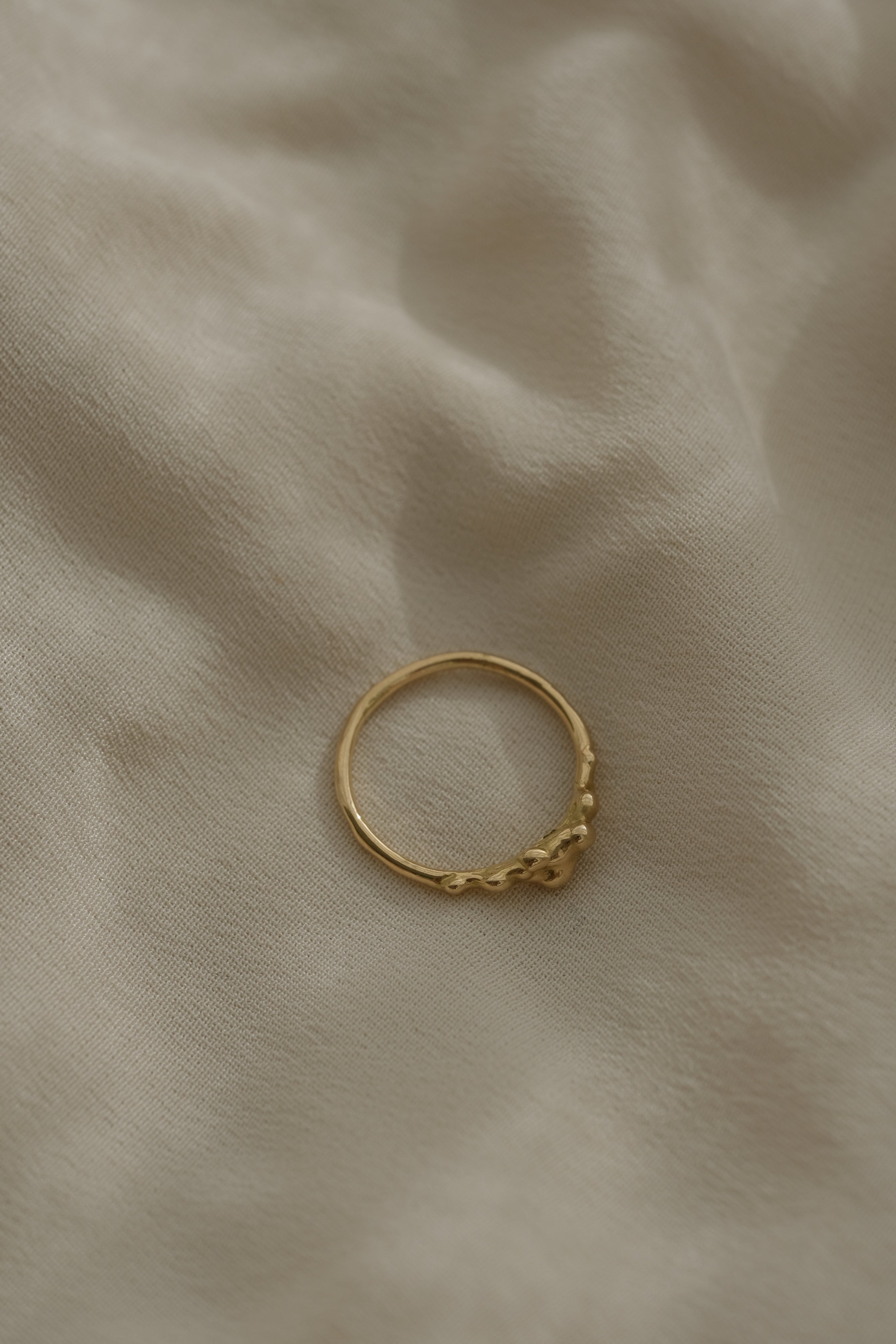 Handmade DROP 03 ring in recycled yellow gold, showcasing unique ethical jewelry, crafted in Basel, Switzerland.