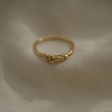 Handmade 18k recycled yellow gold ring, unique and ethical jewelry from Basel, Switzerland on soft fabric.