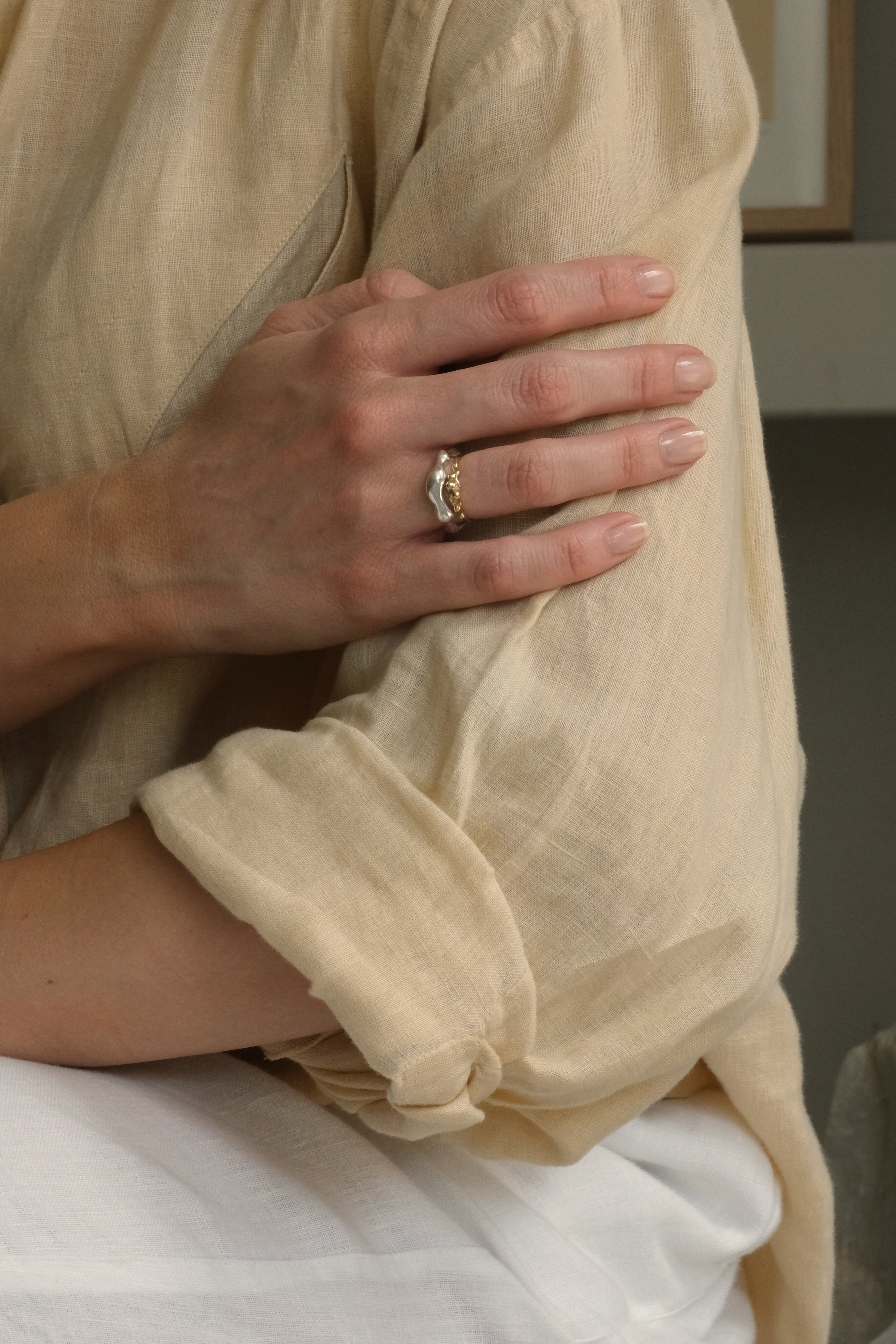 Hand wearing DROP 03 ring two, highlighting ethical and sustainable jewelry, handmade in Basel, Switzerland.