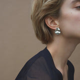 Handmade AROYO small earrings in recycled silver showcased on a model, highlighting ethical and sustainable jewelry.