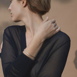 Model showcasing the LOON bangle, an ethical and sustainable jewelry piece, handmade from recycled silver.