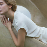 Model showcasing LOON big earrings made of recycled silver, emphasizing ethical and sustainable jewelry.