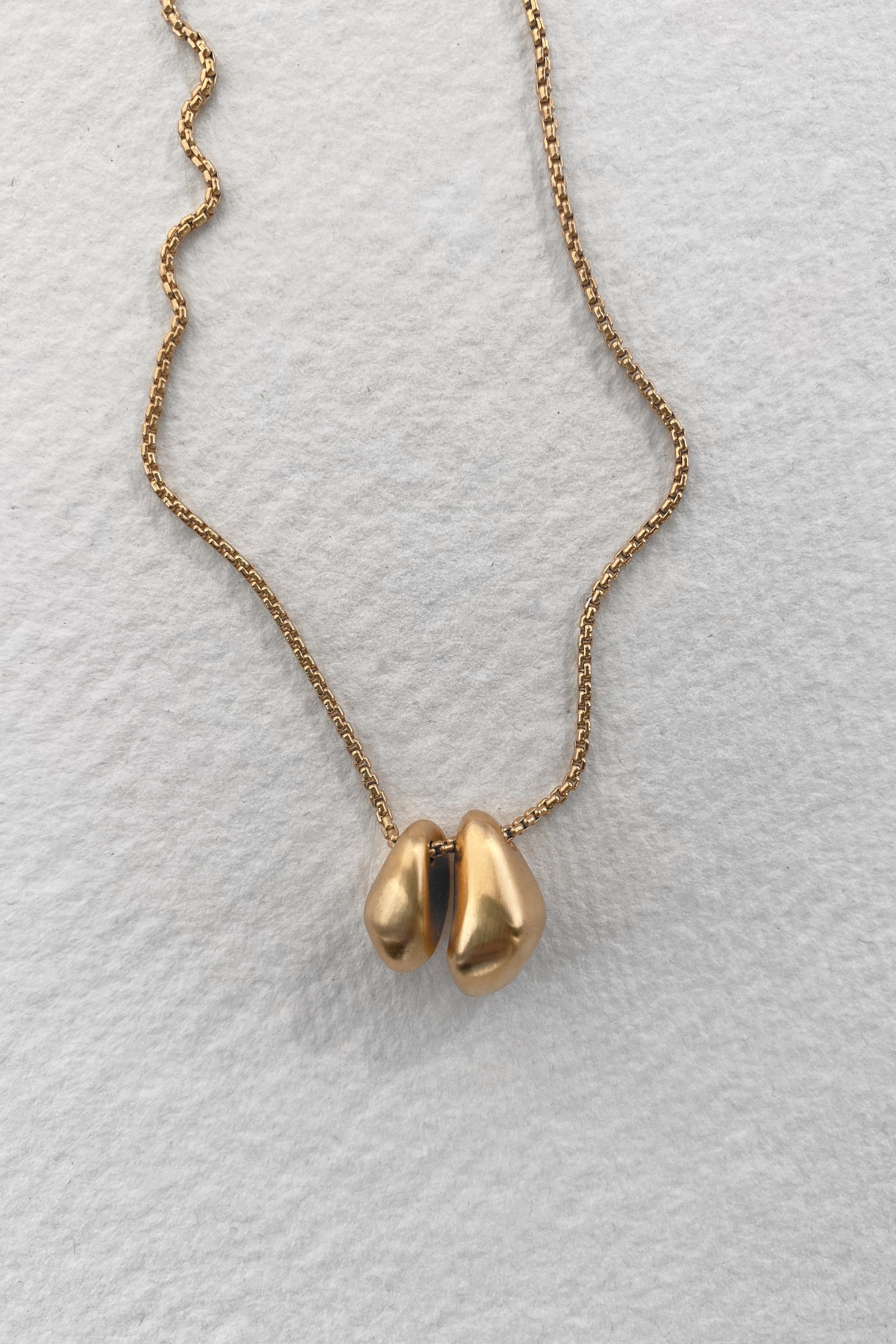ONOA necklace made of 18k recycled gold, handcrafted in Basel, featuring a unique design with a semi-matte finish.