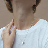 ONOA necklace worn by model, featuring handmade recycled silver and polished design, showcasing ethical and sustainable jewelry.