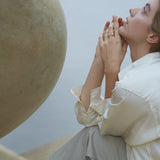 Close-up of a woman wearing the ONOA ring, showcasing its handmade, ethical design in a serene setting.