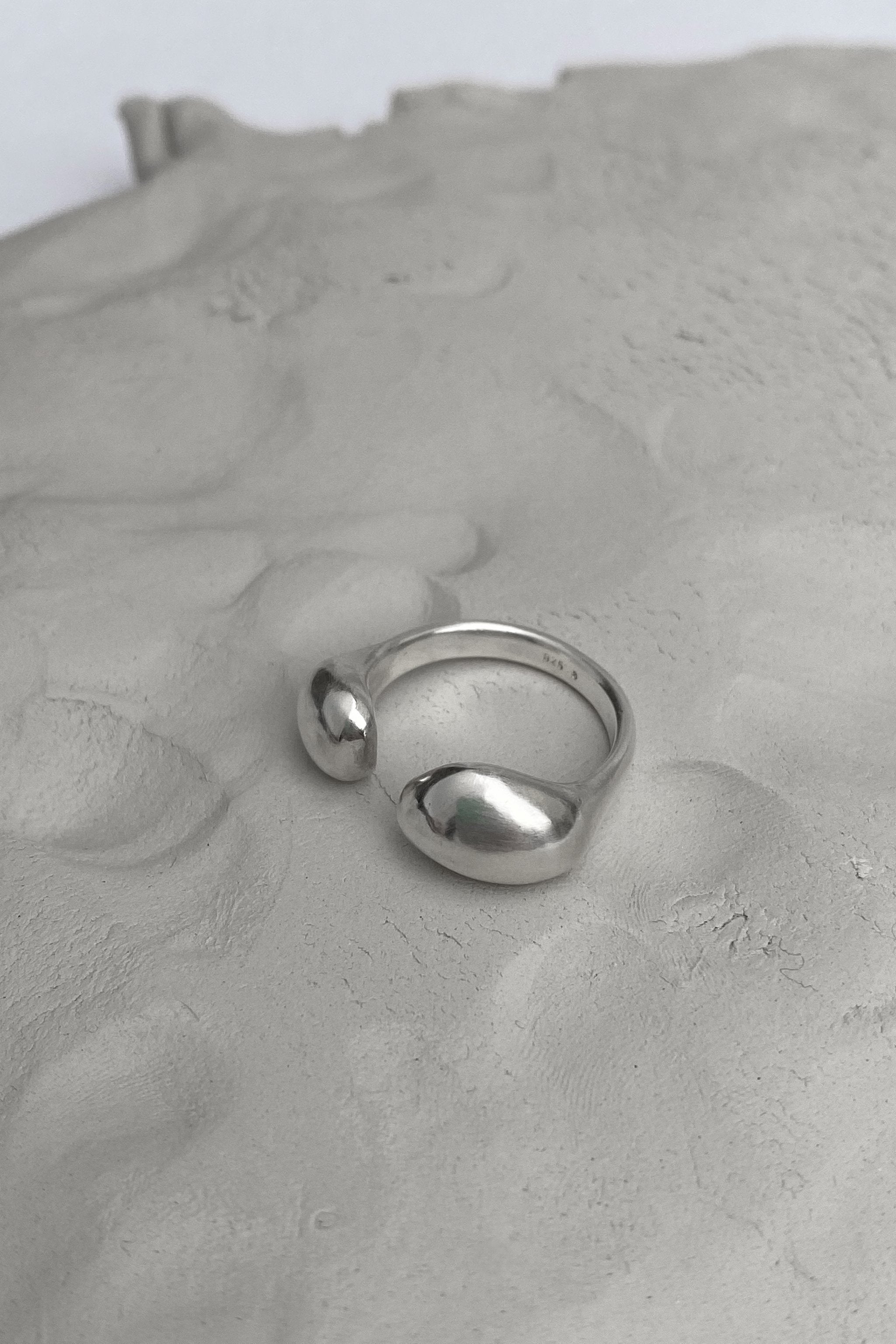 ONOA handmade ring in recycled silver, featuring a semi-matte finish on a textured background, showcasing ethical jewelry.