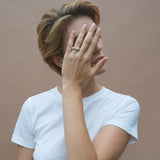 Model showcasing ONOA ring, a handmade ethical and sustainable jewelry piece in recycled gold and silver.