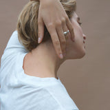 Woman wearing ONOA ring, showcasing ethical handmade jewelry made of recycled gold and silver.