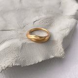 YERERA small handmade ring on soft grey surface, made from 18k gold-plated brass for ethical jewelry lovers.