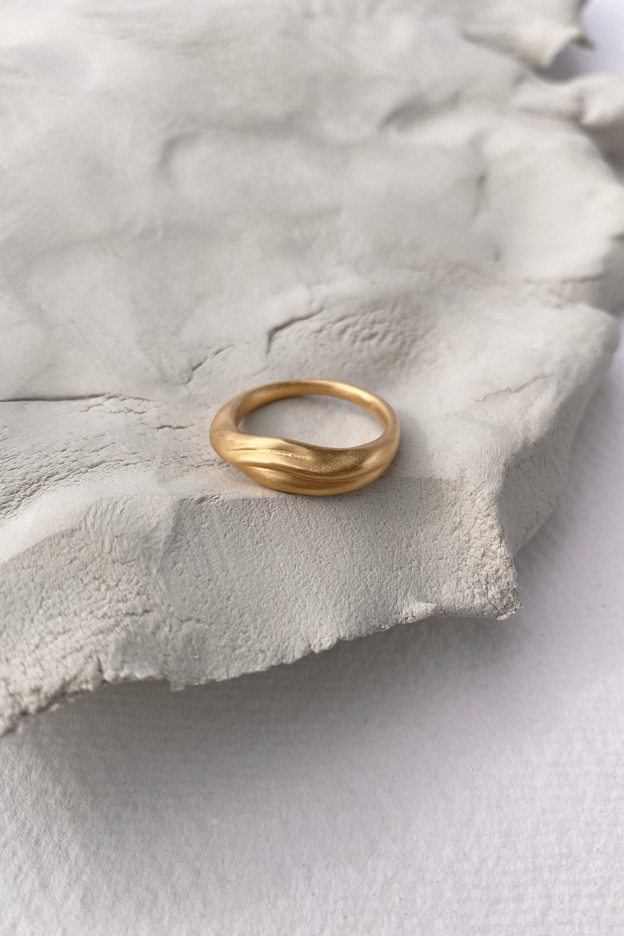 YERERA small handmade ring on soft grey surface, made from 18k gold-plated brass for ethical jewelry lovers.