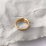YERERA small ring, 18k gold-plated brass, handmade ethical jewelry on textured surface.
