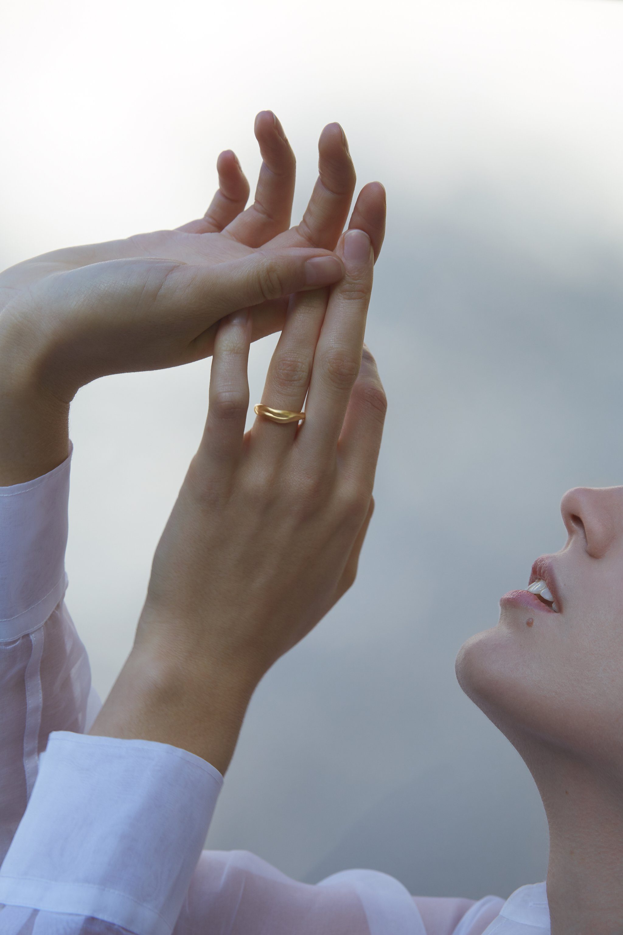 Woman wearing YERERA small ring, showcasing ethical and sustainable jewelry with a handcrafted design.