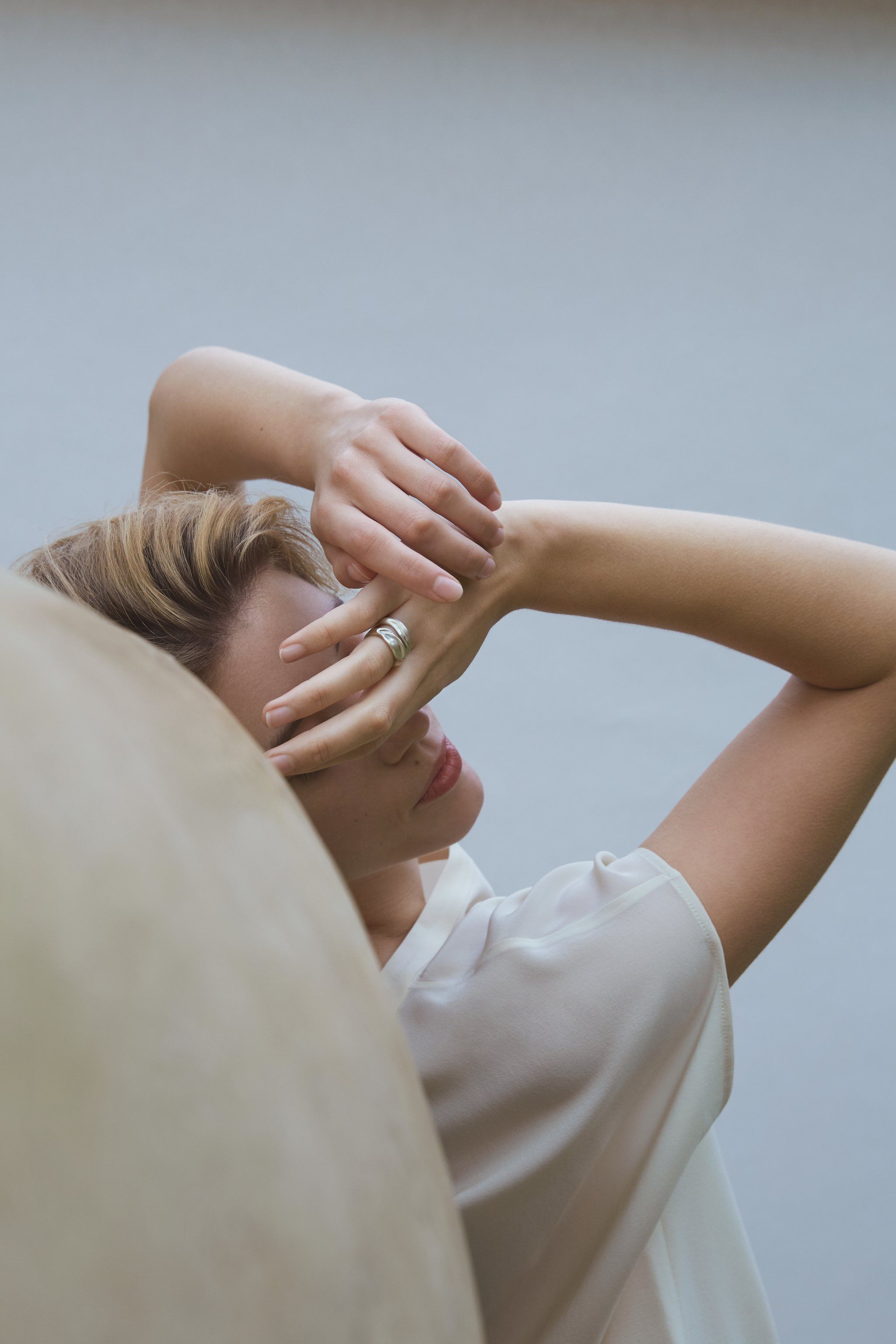 Model wearing YERERA small ring, showcasing ethical handmade jewelry in 18k gold-plated brass or recycled silver.