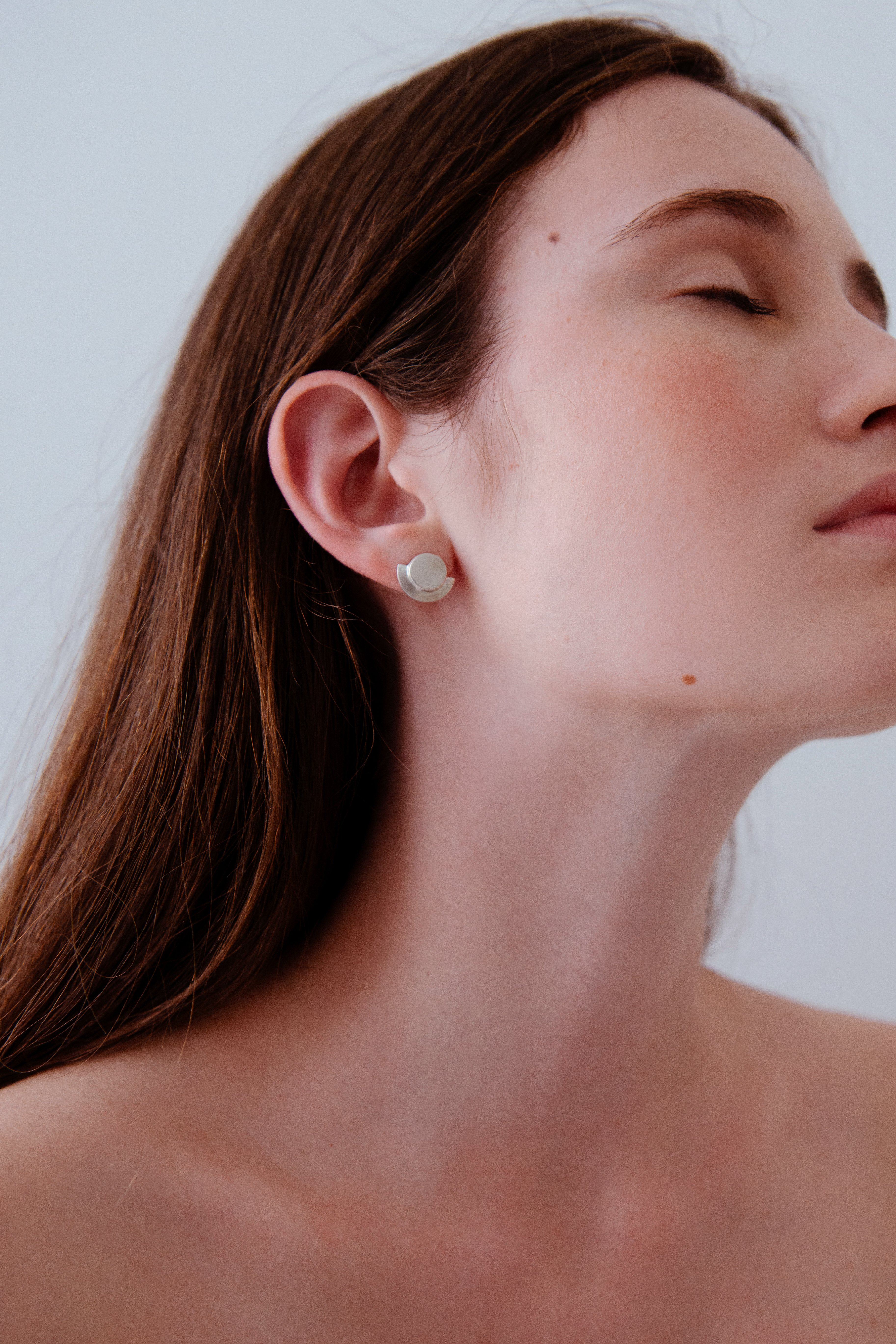 Model wearing MOONLIGHT earrings, handmade ethical jewelry in recycled silver, showcasing sustainable craftsmanship.