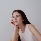 Model showcasing handmade PEBBLE earrings, emphasizing ethical sustainable jewelry and a timeless aesthetic.