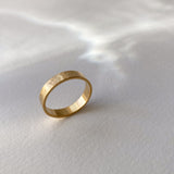ISIA big ring in 18k gold-plated brass with a hammered texture, representing ethical handmade jewelry.