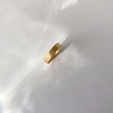 ISIA big ring in 18k gold-plated brass with a hammered finish, showcasing ethical and handmade jewelry.