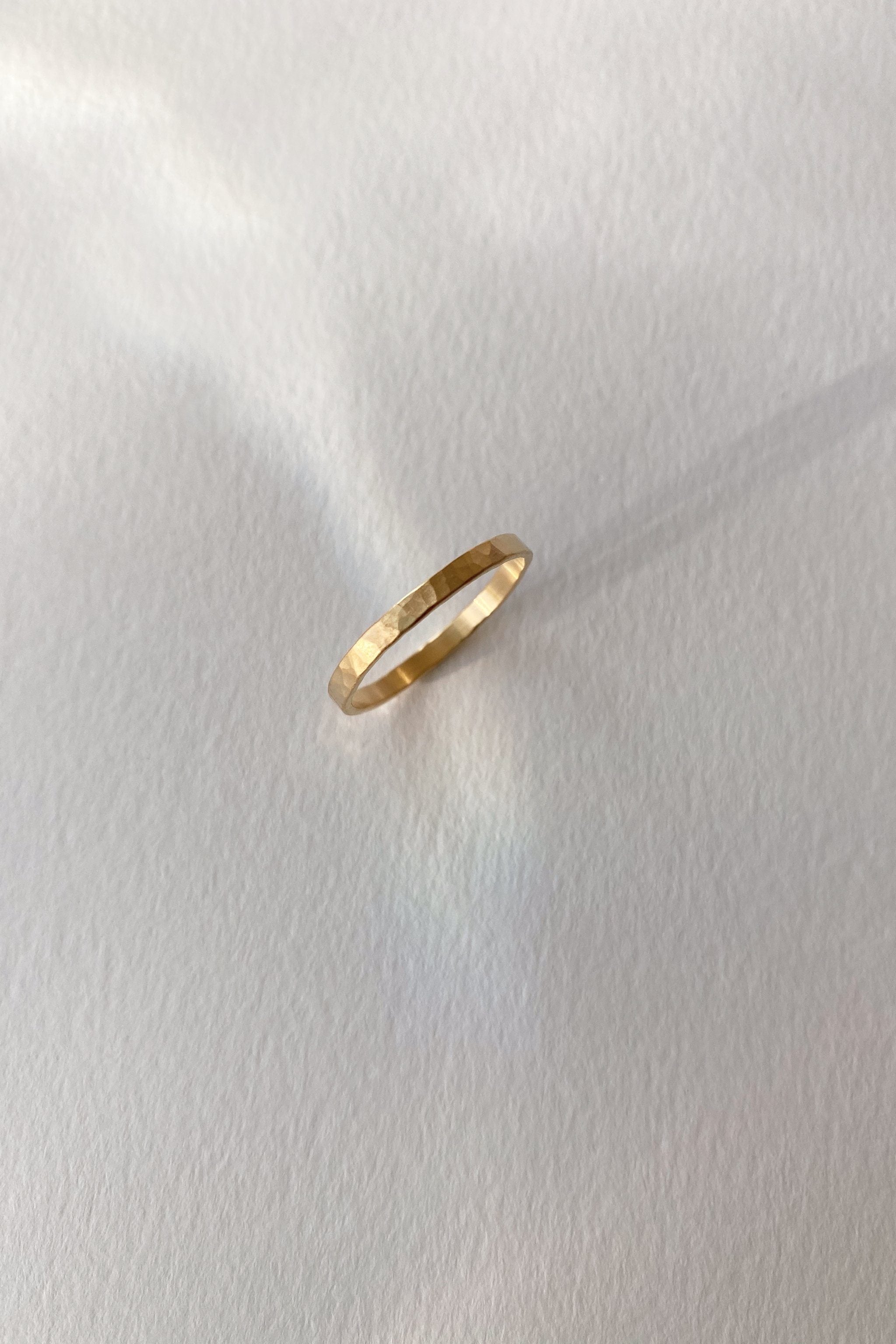 ISIA small ring in 18k gold-plated brass with a semi-matte hammered surface, handcrafted ethical jewelry.