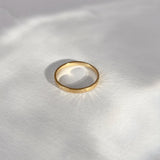 ISIA small ring in 18k gold-plated brass, handmade ethical jewelry with a semi-matte finish, highlighting sustainability.