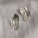 AJUN earrings made of recycled silver, showcasing a matte surface and timeless handmade design, highlighting ethical jewelry.