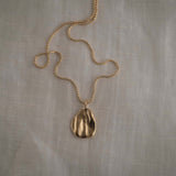 AJUN necklace in 18k gold-plated recycled silver, featuring a semi-matte pendant, handmade ethical jewelry.