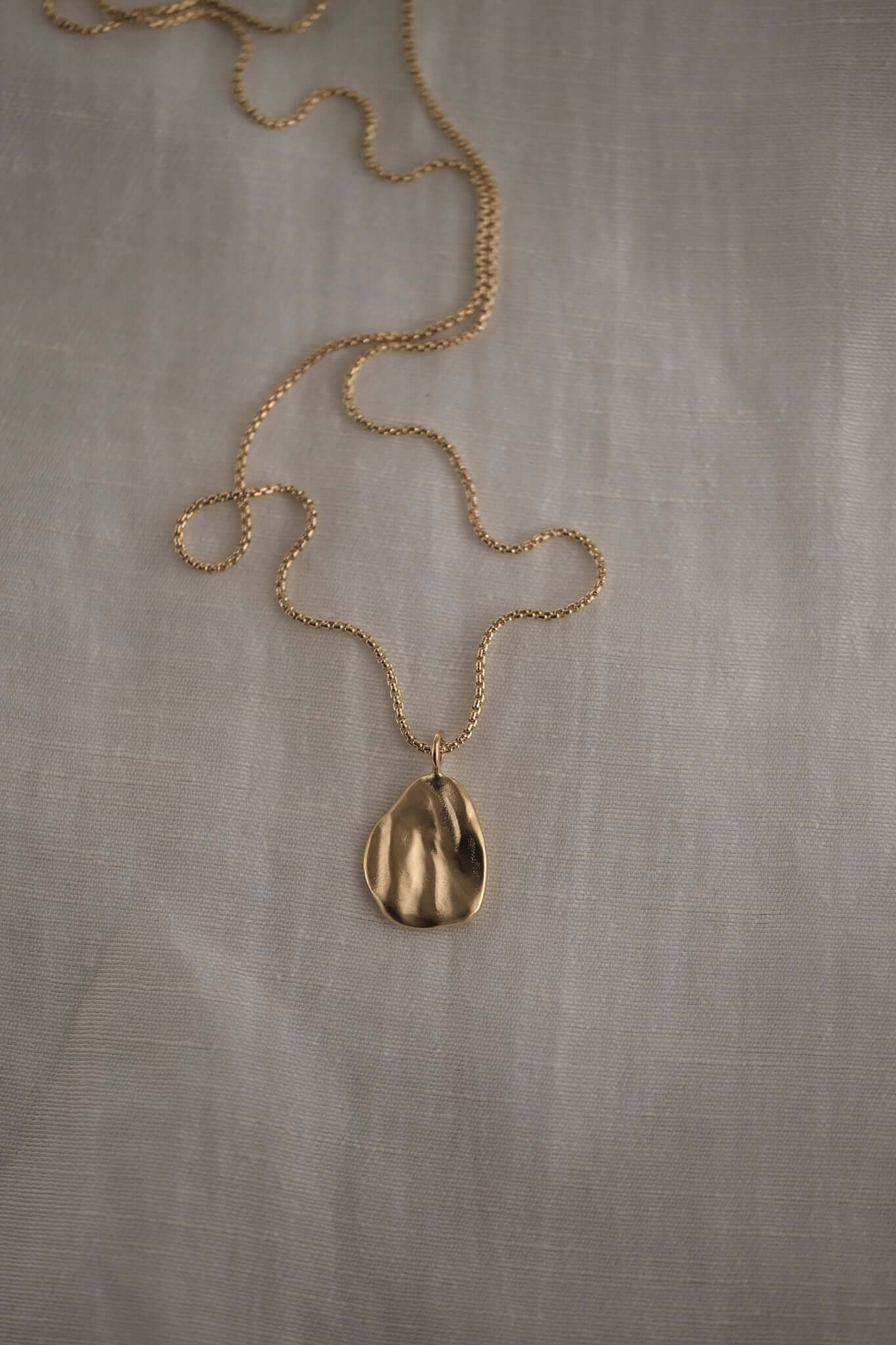 AJUN necklace crafted from 18k recycled gold with a unique pendant, handcrafted in Basel, Switzerland.