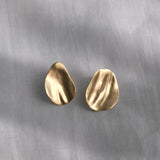 EIRA solo earrings in 18k gold-plated recycled silver with a matte surface, showcasing sustainable and handmade ethical jewelry.