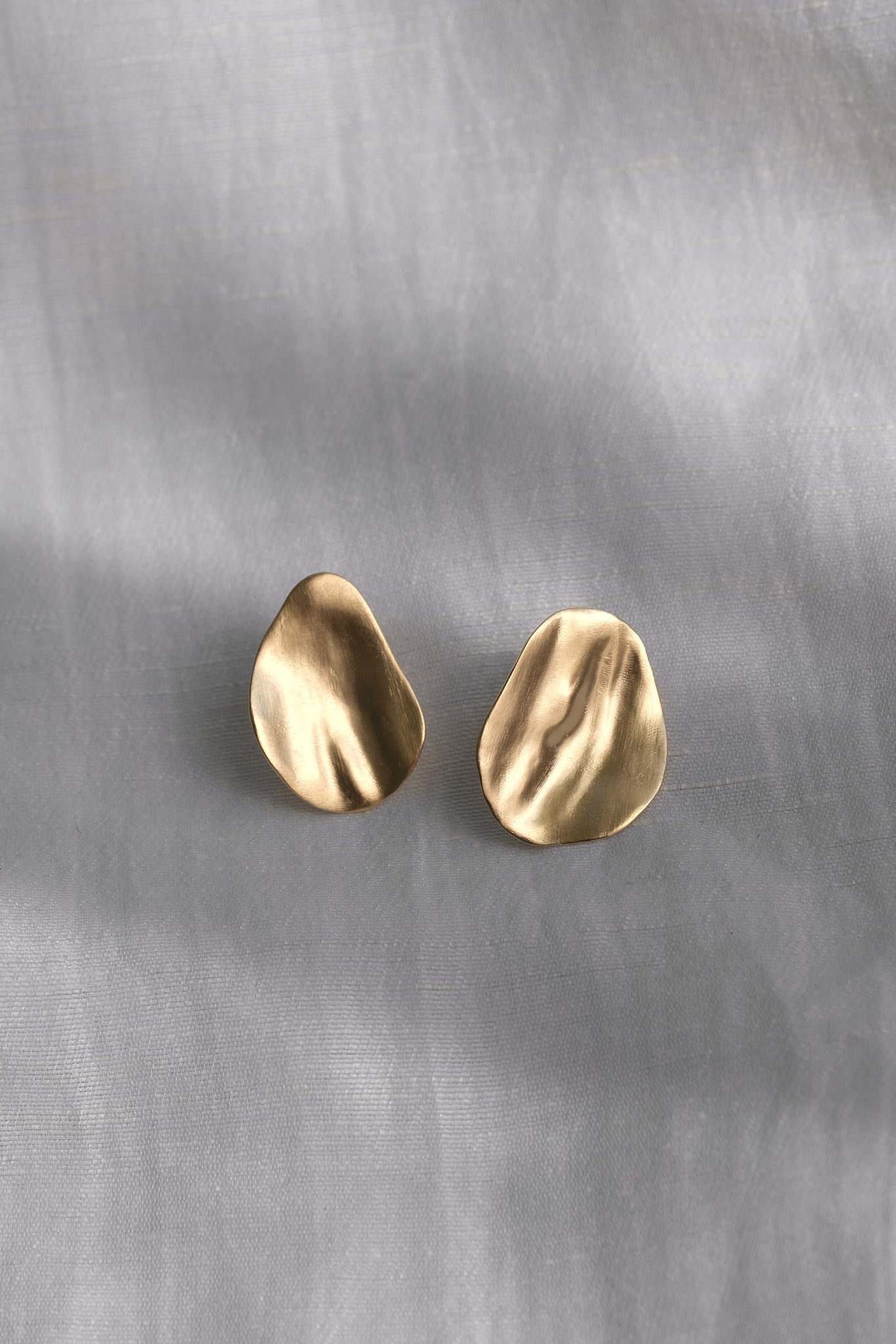 EIRA solo earrings in 18k gold-plated recycled silver with a matte surface, showcasing sustainable and handmade ethical jewelry.