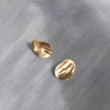 EIRA solo earrings in 18k recycled gold with matte surface, showcasing ethical handmade jewelry.