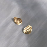 Handcrafted EIRA solo earrings in 18k recycled gold, organic shape, designed in Basel, Switzerland.