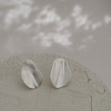 EIRA solo earrings in recycled silver with asymmetrical matte finish, handmade ethical jewelry.