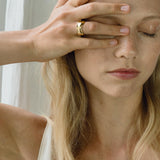 Woman wearing KAYU ring, showcasing ethical handmade jewelry made of recycled gold and silver.