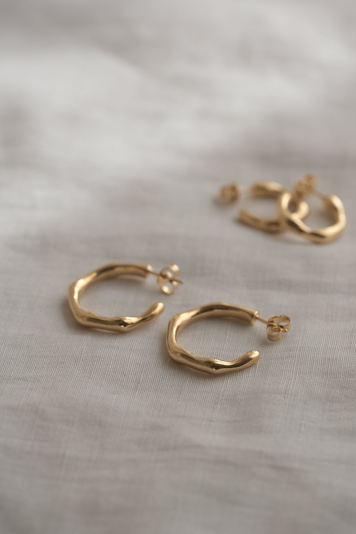 LUMI big earrings made of 18k gold-plated recycled silver, handcrafted ethical jewelry, featuring a natural shiny surface.