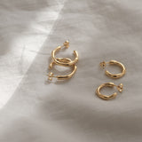 LUMI small earrings in recycled gold and silver, handcrafted ethically, showcasing a natural shiny surface.