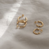 Handcrafted LUMI small earrings in 18k recycled gold, sustainable and organic, polished in Basel, Switzerland.