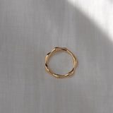 LUMI ring in 18k gold plating, showcasing handmade ethical jewelry with a shiny surface on a neutral background.