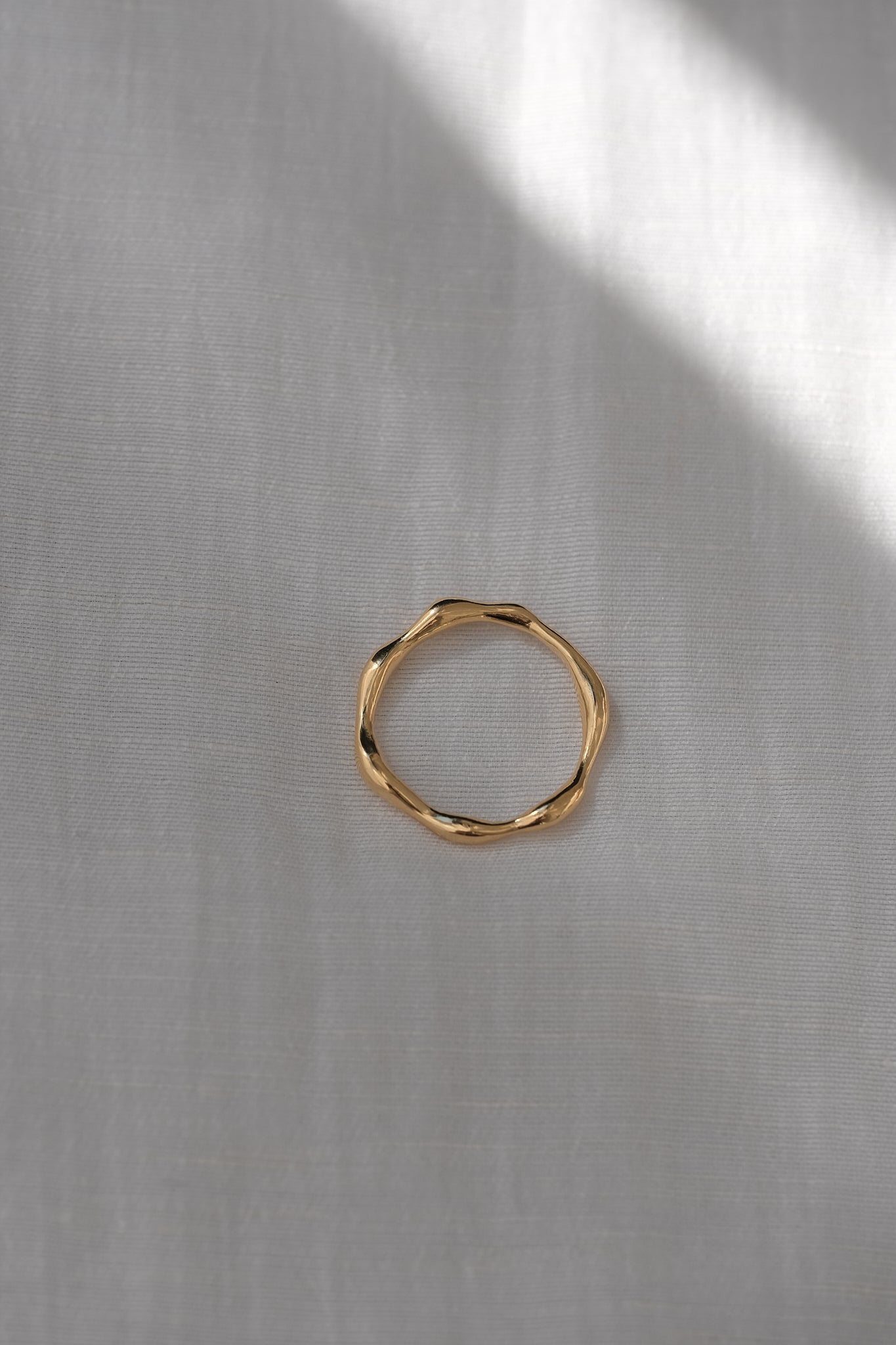 LUMI ring in 18k gold plating, showcasing handmade ethical jewelry with a shiny surface on a neutral background.