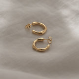 Handcrafted 18k recycled gold small earrings with natural shiny surface, designed and polished in Basel, Switzerland.