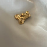 Handmade MOA brooch in 18k gold-plated recycled silver on silky fabric, showcasing sustainable, ethical jewelry.
