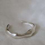 Handmade MOA cuff in recycled silver, showcasing a natural shiny surface of ethical jewelry.