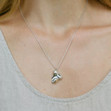 Handmade MOA necklace featuring recycled silver pendant on a delicate chain, showcasing ethical jewelry craftsmanship.
