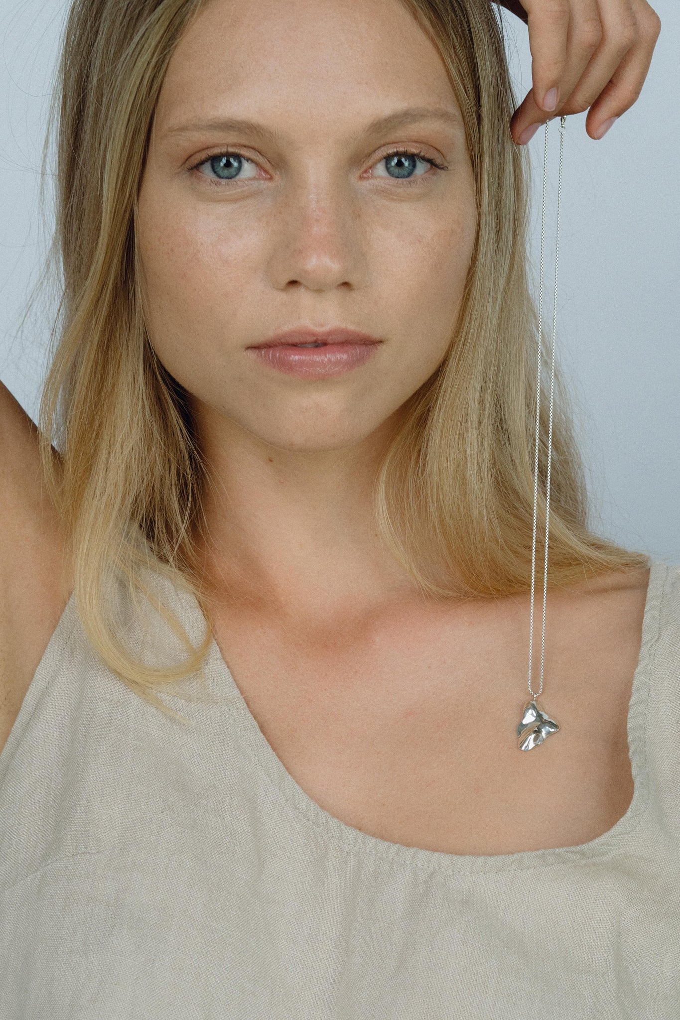 Model showcasing the MOA necklace made of recycled silver, highlighting ethical jewelry and sustainable fashion.
