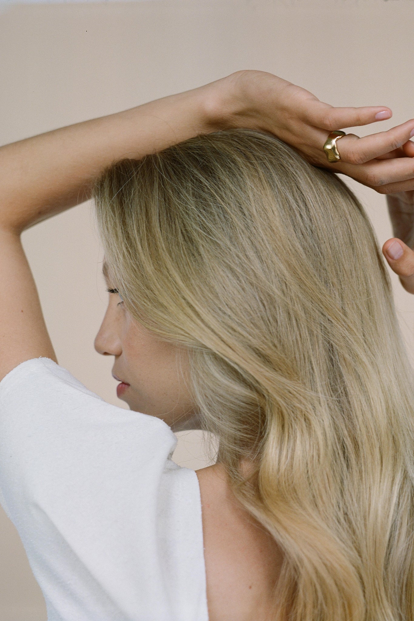 Side view of a woman showcasing the handmade MOA ring, highlighting ethical jewelry made from recycled silver and gold.