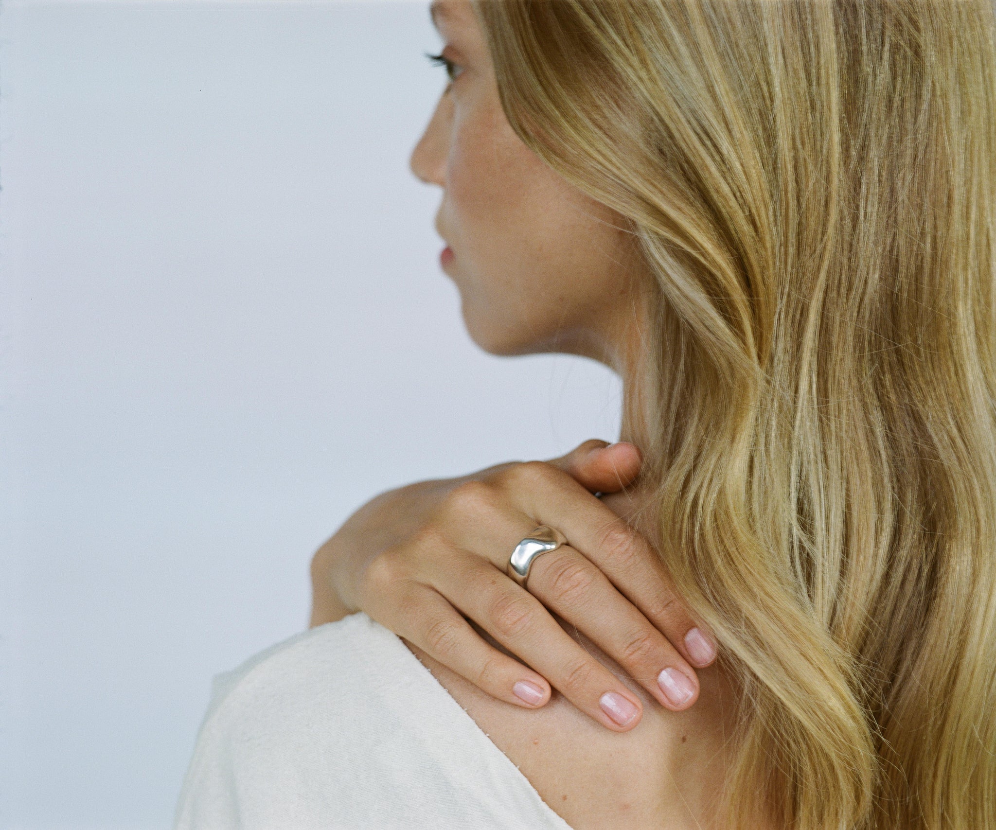 Woman wearing the MOA ring, featuring recycled silver and showcasing ethical handmade jewelry.