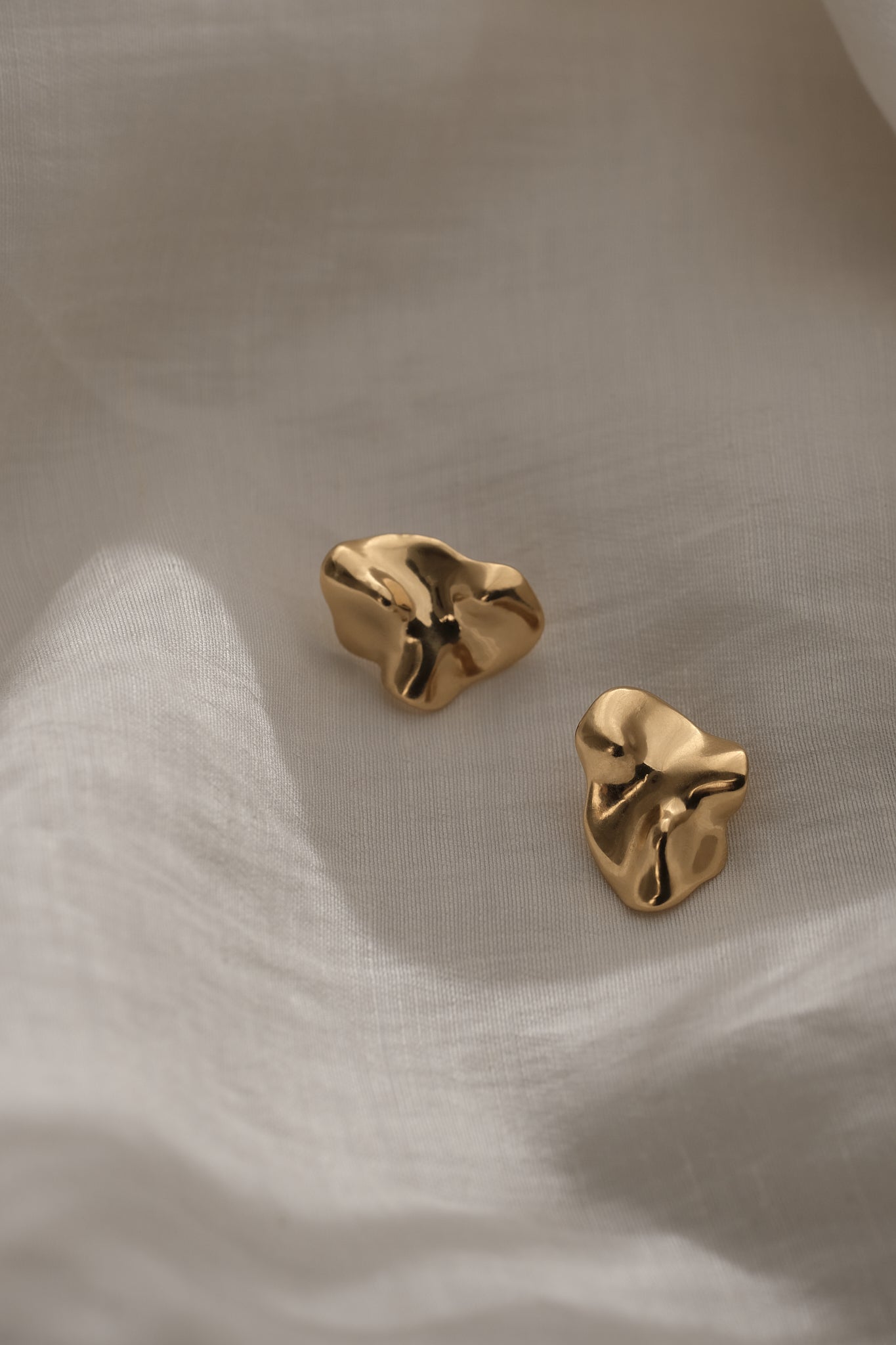 Handmade MOA earrings in 18k gold plating, crafted from recycled materials for sustainable, ethical jewelry.