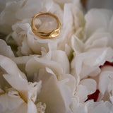 YERERA big ring in 18k gold-plated brass, nestled among white peonies, showcasing ethical and sustainable jewelry craftsmanship.